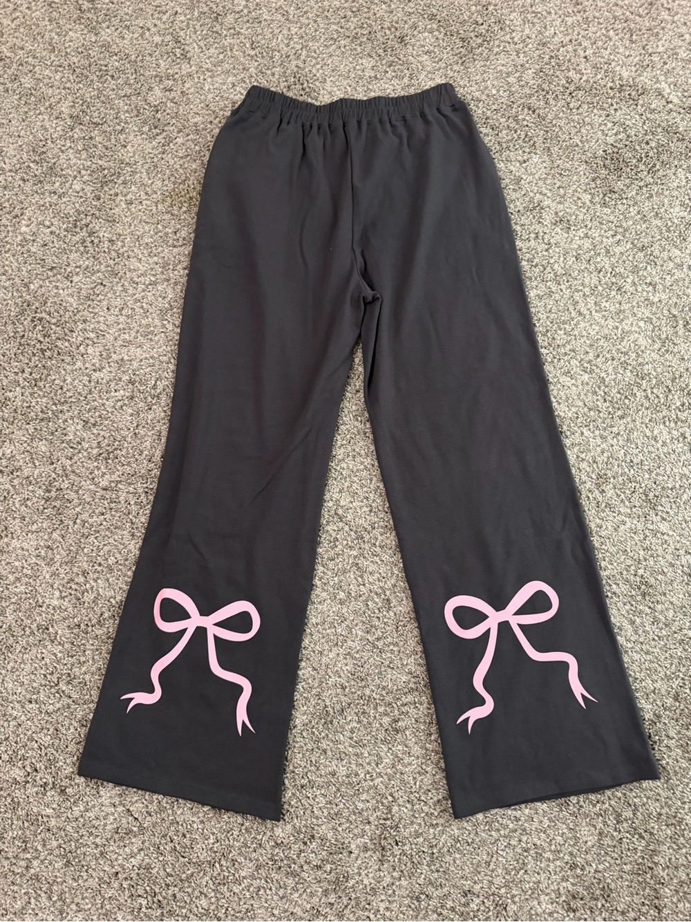 Women’s charcoal grey sweatpants with Pink Bow Accent. Size medium